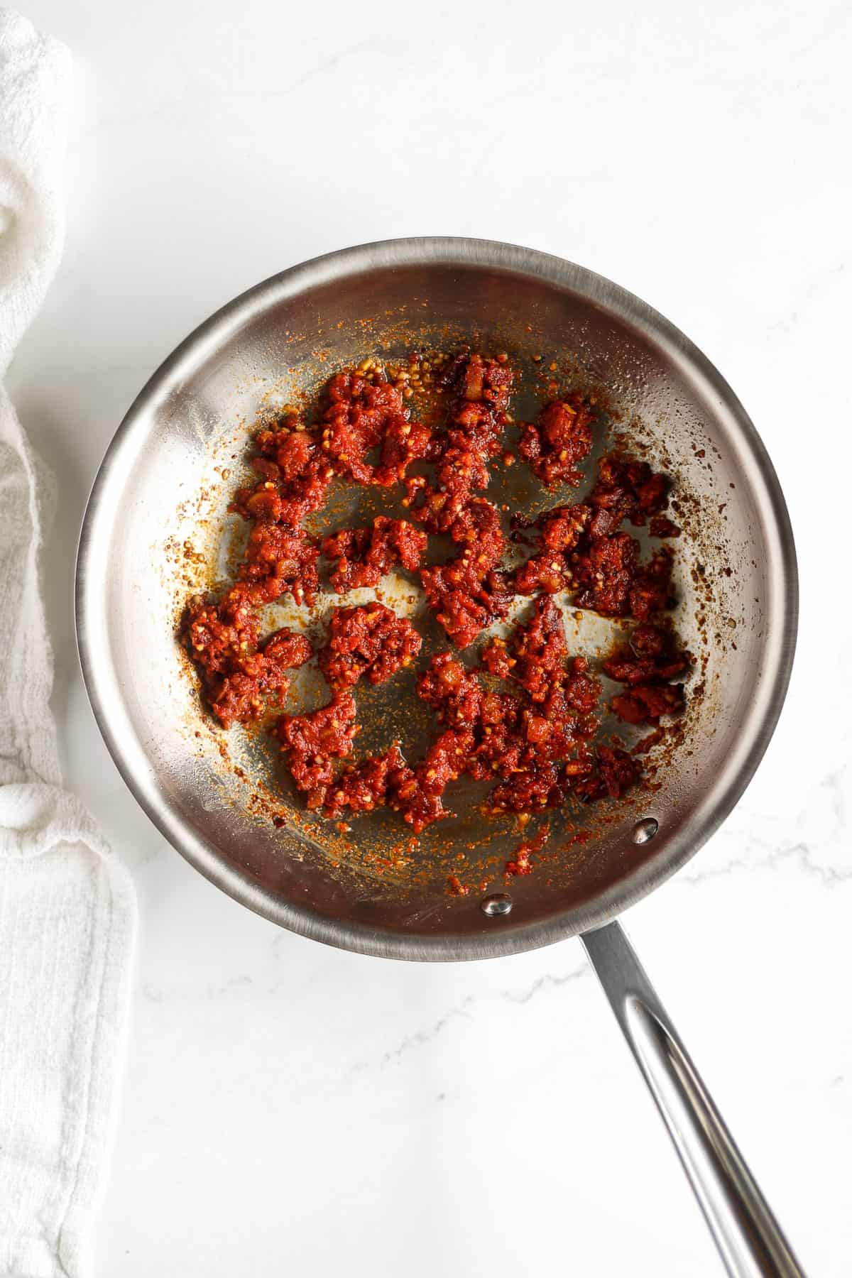 Sauce with tomato paste and crushed red pepper.