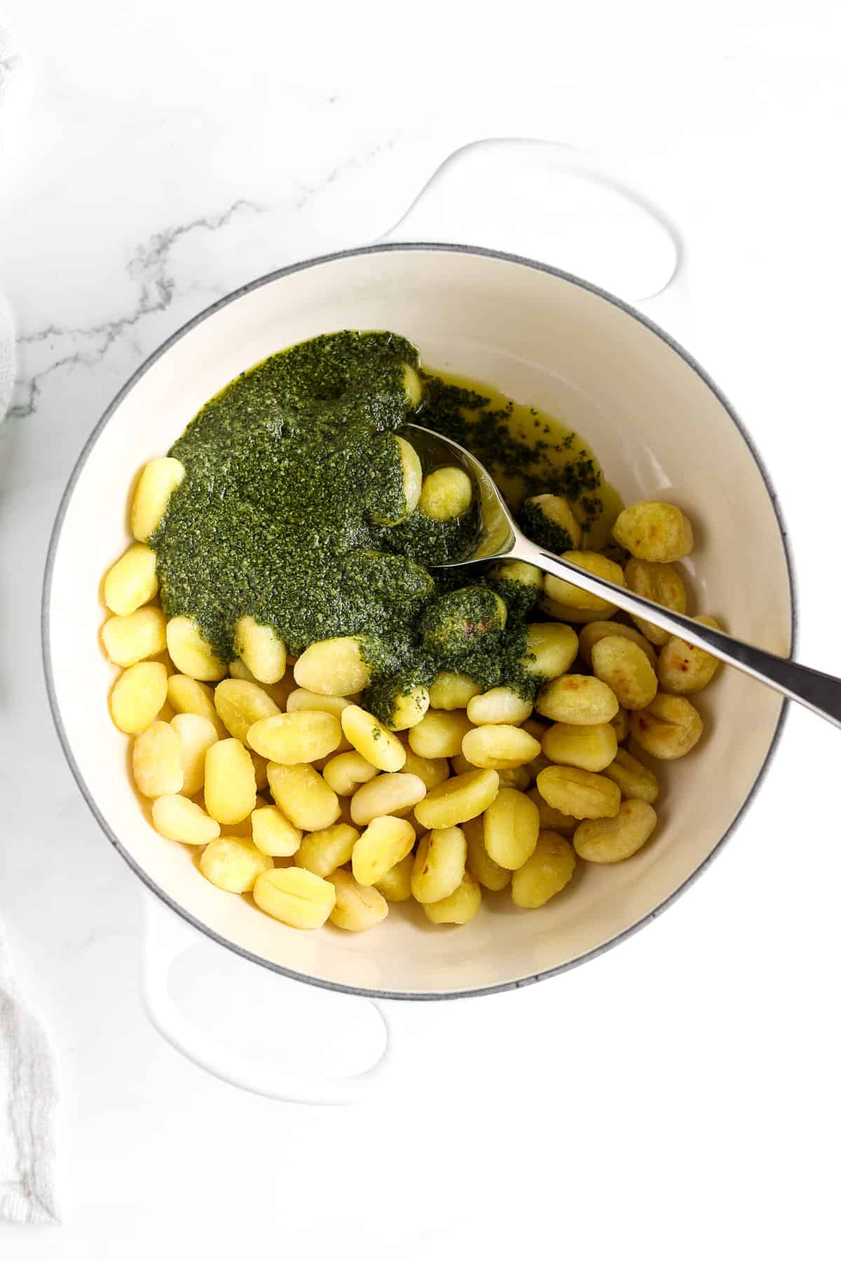 Toasted gnocchi topped with homemade basil pesto.
