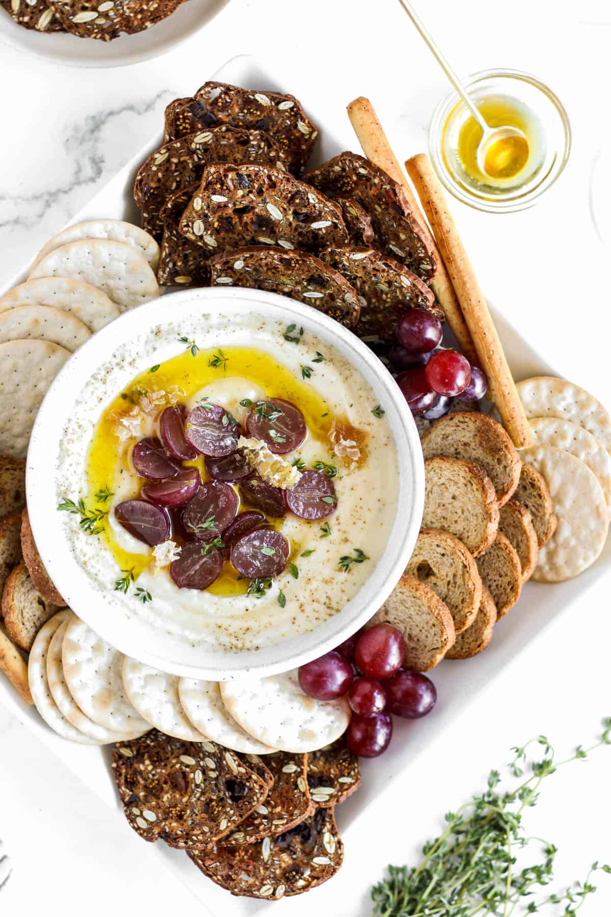 Whipped ricotta dip topped with grapes and honeycomb.