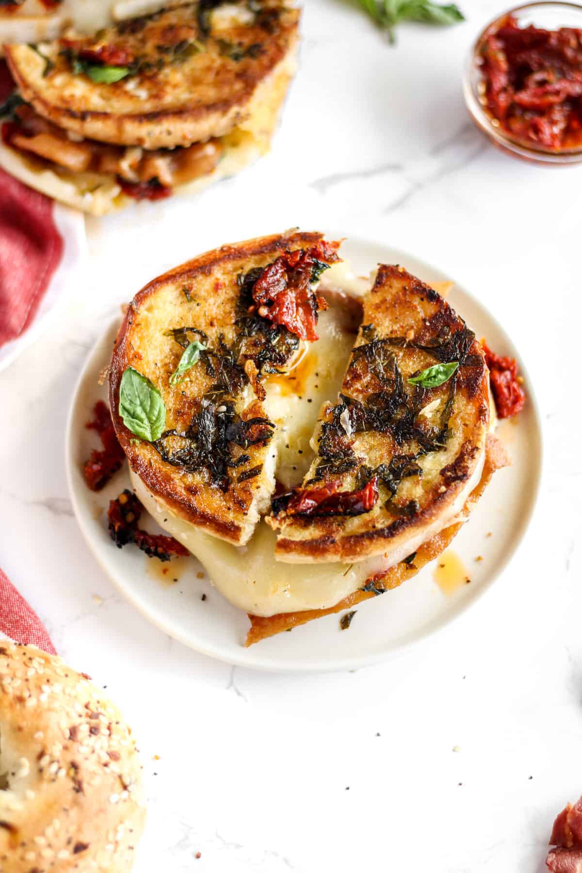 Bagel grilled cheese with bacon, sun dried tomatoes, and basil.