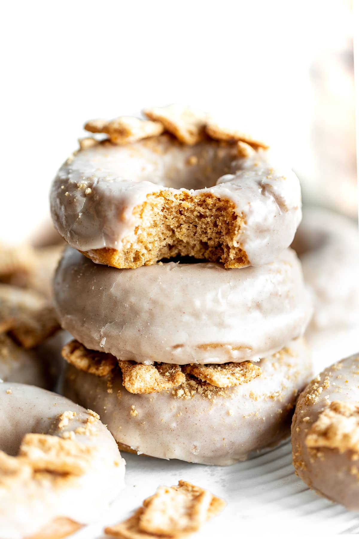 Stack of cinnamon donuts with bite.