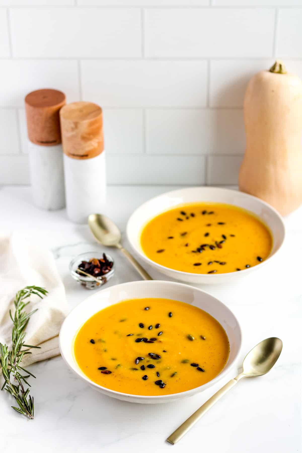 Butternut squash and carrot soup in bowls.
