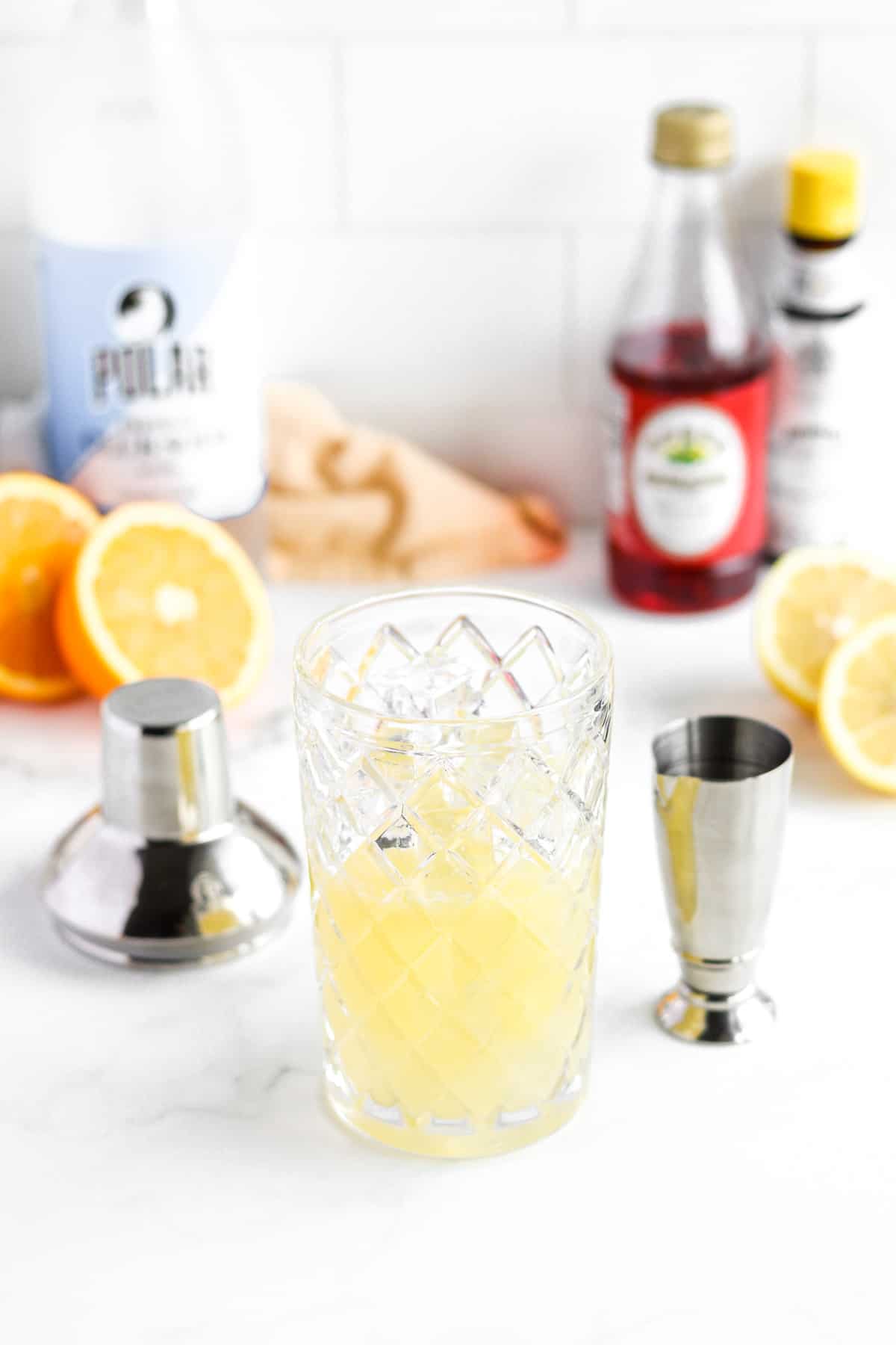 Citrus juice in cocktail shaker with ice.